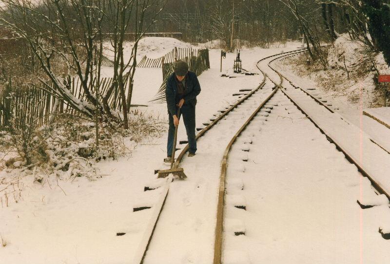 snow03.jpg - However, the snow on top of the rails prevented any real progress so out came the broom. Nigel clears the rail tops in Brockham loop.